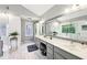 Bright bathroom featuring marble floors, double vanity, walk-in glass shower, and a soaking tub under a window at 989 Pinfeather Ct, Lawrenceville, GA 30043