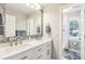 Bright bathroom featuring a double vanity with marble countertops and brushed bronze hardware at 989 Pinfeather Ct, Lawrenceville, GA 30043