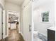 Hallway view of an updated bathroom with a sliding barn door, leading to a kitchen with an island at 989 Pinfeather Ct, Lawrenceville, GA 30043