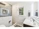 Modern bathroom with a walk-in shower with decorative tile, white tiled walls, and updated vanity at 989 Pinfeather Ct, Lawrenceville, GA 30043