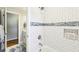 Updated bathroom features subway tile in the shower with built-in shelving for bath and body products at 989 Pinfeather Ct, Lawrenceville, GA 30043