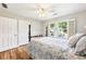 Bedroom with hardwood floors, white trim, and large windows with plantation shutters at 989 Pinfeather Ct, Lawrenceville, GA 30043