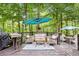 Outdoor deck featuring stylish furniture, a grill, and shaded seating, perfect for relaxation and entertaining at 989 Pinfeather Ct, Lawrenceville, GA 30043