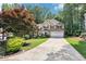 Beautiful two-story home with well-maintained landscaping, a long driveway, and an attached two-car garage at 989 Pinfeather Ct, Lawrenceville, GA 30043