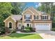 Charming two-story home with a manicured lawn and a two-car garage at 989 Pinfeather Ct, Lawrenceville, GA 30043