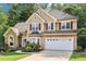 Charming two-story home with a manicured lawn and a two-car garage at 989 Pinfeather Ct, Lawrenceville, GA 30043