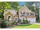 Charming two-story home with a manicured lawn and a two-car garage at 989 Pinfeather Ct, Lawrenceville, GA 30043