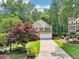 Two-story home with a two car garage and mature trees at 989 Pinfeather Ct, Lawrenceville, GA 30043