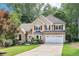 Charming two-story traditional home with well-manicured lawn, two-car garage and lush landscaping at 989 Pinfeather Ct, Lawrenceville, GA 30043