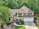Stunning two-story home featuring manicured landscaping, shutters, a two-car garage, and architectural details at 989 Pinfeather Ct, Lawrenceville, GA 30043