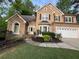 Charming two-story home with manicured lawn and two car garage at 989 Pinfeather Ct, Lawrenceville, GA 30043
