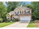 Charming two-story traditional home with well-manicured lawn, two-car garage and lush landscaping at 989 Pinfeather Ct, Lawrenceville, GA 30043
