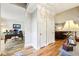Hallway leading to an office and a glimpse of the living room with beautiful hardwood floors at 989 Pinfeather Ct, Lawrenceville, GA 30043