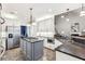 Elegant kitchen featuring white cabinets, center island, and modern stainless steel appliances at 989 Pinfeather Ct, Lawrenceville, GA 30043