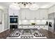 Stylish kitchen features stainless appliances, a gas cooktop, granite countertops, and white subway tile backsplash at 989 Pinfeather Ct, Lawrenceville, GA 30043