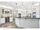 Bright kitchen features white cabinets, granite countertops, and stainless steel appliances at 989 Pinfeather Ct, Lawrenceville, GA 30043
