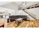 Spacious living room with hardwood floors open to the kitchen and stairs to the second floor at 989 Pinfeather Ct, Lawrenceville, GA 30043