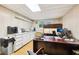 Functional office space featuring built-in storage, wood desk, and natural light from the window at 989 Pinfeather Ct, Lawrenceville, GA 30043