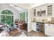 Bright sunroom with large windows, a wine fridge, and plenty of seating at 989 Pinfeather Ct, Lawrenceville, GA 30043