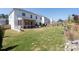 Expansive backyard featuring a screened porch, manicured lawn, and mature landscaping at 146 Citrine Way, Acworth, GA 30101