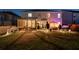 Experience the evening glow of this home's backyard, boasting a screened porch, hot tub, and beautifully lit landscaping at 146 Citrine Way, Acworth, GA 30101