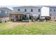 Backyard featuring a screened porch, patio, hot tub, and a well-maintained lawn ideal for relaxation and recreation at 146 Citrine Way, Acworth, GA 30101