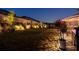 Beautifully illuminated backyard with manicured landscaping and a cozy patio area for evening relaxation at 146 Citrine Way, Acworth, GA 30101