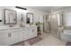 Bright and airy bathroom with double vanities, modern fixtures, a glass-enclosed shower, and a soaking tub at 146 Citrine Way, Acworth, GA 30101