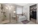 Well-lit bathroom featuring a glass shower, soaking tub, and walk-in closet creating a spa-like experience at 146 Citrine Way, Acworth, GA 30101