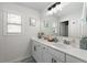 Bright bathroom featuring double sink vanity, large mirror, and tiled floors at 146 Citrine Way, Acworth, GA 30101