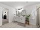 Well-lit bathroom featuring double vanities and modern fixtures, complemented by plants and decor at 146 Citrine Way, Acworth, GA 30101