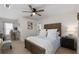 Bedroom with queen bed, ceiling fan, desk area, and neutral colored walls and carpet at 146 Citrine Way, Acworth, GA 30101
