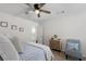 Cozy bedroom with a ceiling fan, queen bed, accent chair, and natural light at 146 Citrine Way, Acworth, GA 30101