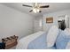 Bright bedroom with ceiling fan, blue bedding, white walls and carpet, and decor at 146 Citrine Way, Acworth, GA 30101