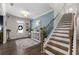 Inviting foyer featuring a staircase, a decorative table with plants, and a beautiful front door at 146 Citrine Way, Acworth, GA 30101
