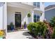 Charming front porch with well-maintained landscaping, a decorative wreath, and a black front door at 146 Citrine Way, Acworth, GA 30101