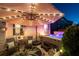 Relax under the illuminated umbrella near a hot tub on an outdoor patio, surrounded by lush plants and comfortable seating at 146 Citrine Way, Acworth, GA 30101