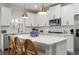 Close up of kitchen featuring an island with seating, white cabinets, subway tile backsplash, and pendant lights at 146 Citrine Way, Acworth, GA 30101