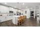 Bright kitchen includes white cabinets, subway tile backsplash, stainless steel appliances and an island with seating at 146 Citrine Way, Acworth, GA 30101