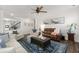 Comfortable living room with a ceiling fan, multiple seating options, and a stylish blue rug at 146 Citrine Way, Acworth, GA 30101