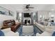Spacious living room with large sofas, blue patterned rug, fireplace, and view into the kitchen at 146 Citrine Way, Acworth, GA 30101