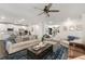 Open-concept living room featuring a neutral palette, comfortable seating, and a view of the kitchen at 146 Citrine Way, Acworth, GA 30101