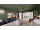Living room featuring green walls and ceiling, TV, and an accent chair at 146 Citrine Way, Acworth, GA 30101