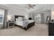 Spacious bedroom featuring tray ceilings, neutral walls, large window for natural light and a large dark wood bed frame at 146 Citrine Way, Acworth, GA 30101