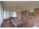 Enclosed sunroom featuring brick walls, large windows, and a ceiling fan at 3257 Greenvale Way, Decatur, GA 30034