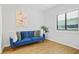 Bright bedroom featuring wood-look flooring, a blue sofa, and ample natural light at 3481 Lakeside Dr # 601, Atlanta, GA 30326
