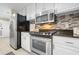 Updated kitchen with stainless steel appliances, granite counters, and white cabinets at 3481 Lakeside Dr # 601, Atlanta, GA 30326
