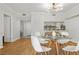 Bright living room with a round dining table, modern lighting, and hardwood floors at 3481 Lakeside Dr # 601, Atlanta, GA 30326