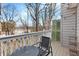 Back deck featuring a metal table and chair with a wooded view at 384 Teal Ct, Roswell, GA 30076