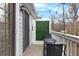 Outdoor balcony with string lights, a small table, and black metal chairs at 384 Teal Ct, Roswell, GA 30076